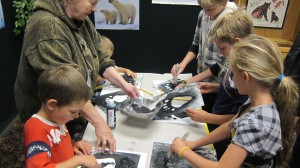 The kids making paw prints with one of the volunteers.